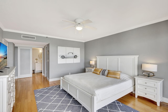 bedroom featuring crown molding, hardwood / wood-style floors, and ceiling fan