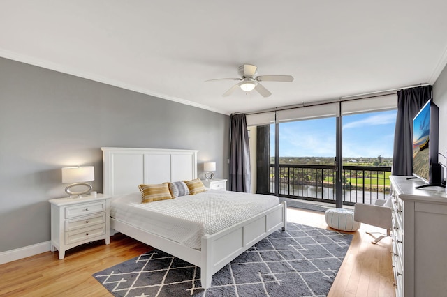 bedroom with hardwood / wood-style flooring, ceiling fan, floor to ceiling windows, ornamental molding, and access to outside