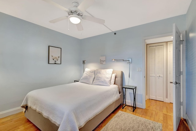 bedroom featuring hardwood / wood-style flooring, a closet, and ceiling fan