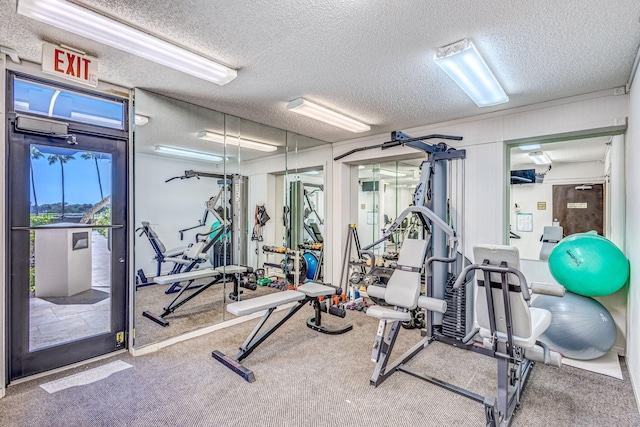 gym featuring carpet floors and a textured ceiling