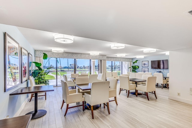 dining space with light hardwood / wood-style flooring