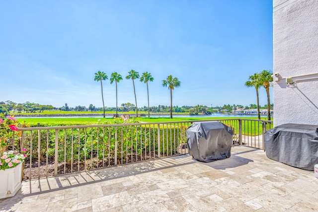 view of patio / terrace featuring a water view and grilling area