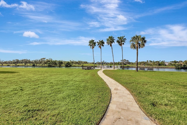 view of property's community with a yard and a water view