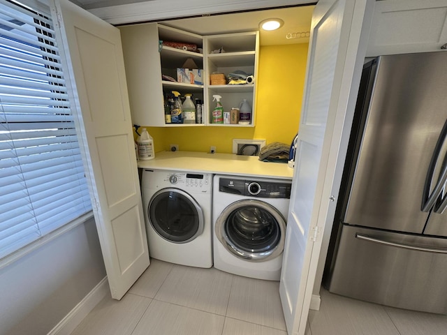 laundry room with plenty of natural light, separate washer and dryer, and light tile patterned floors