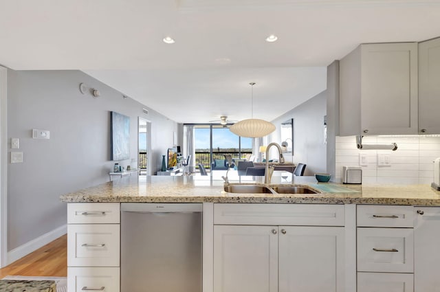 kitchen featuring white cabinetry, dishwasher, sink, and light hardwood / wood-style flooring