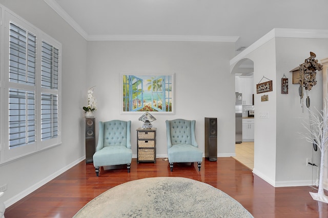 sitting room with dark wood-type flooring and ornamental molding