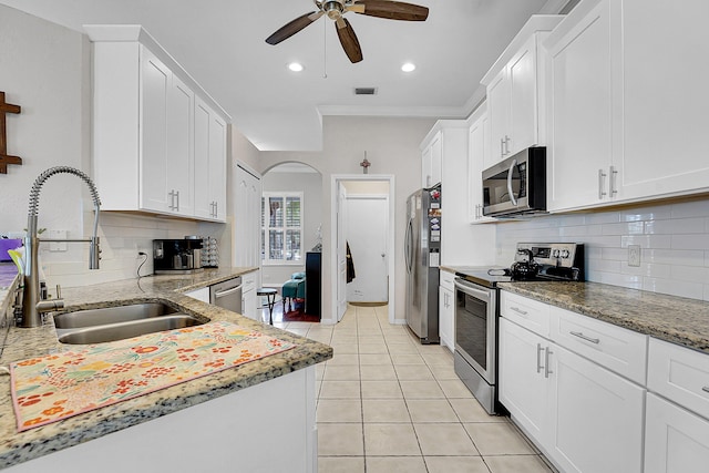 kitchen featuring white cabinetry, sink, ceiling fan, light tile patterned flooring, and appliances with stainless steel finishes