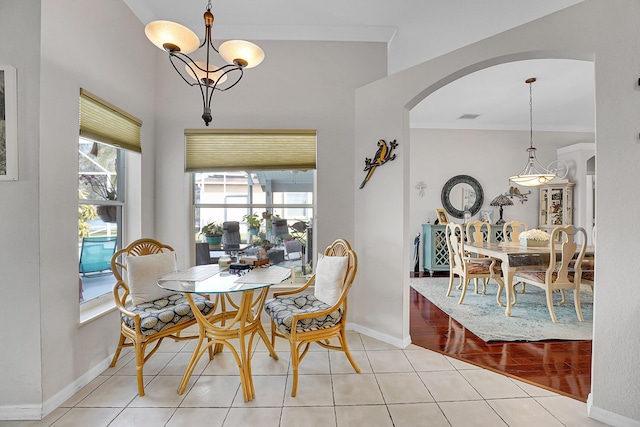 dining room featuring light tile patterned floors and an inviting chandelier