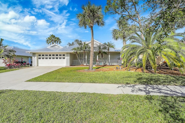 single story home with a porch, a garage, and a front lawn