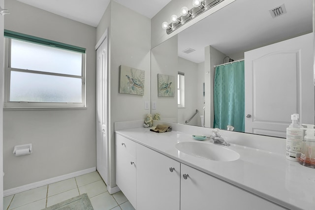 bathroom with tile patterned flooring and vanity