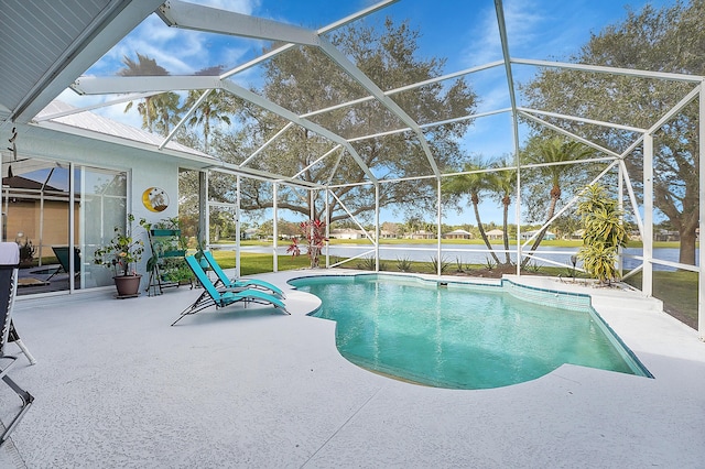 view of pool with a patio area and a lanai