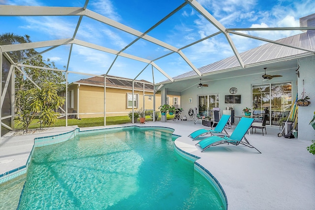 view of swimming pool with ceiling fan, a patio area, and a lanai