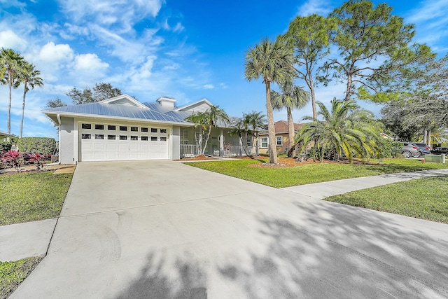 view of front of house featuring a garage and a front lawn