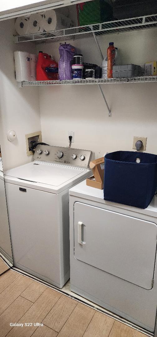 washroom featuring hardwood / wood-style floors and washer and clothes dryer