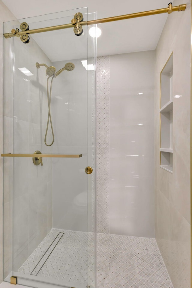 bathroom with a shower with door