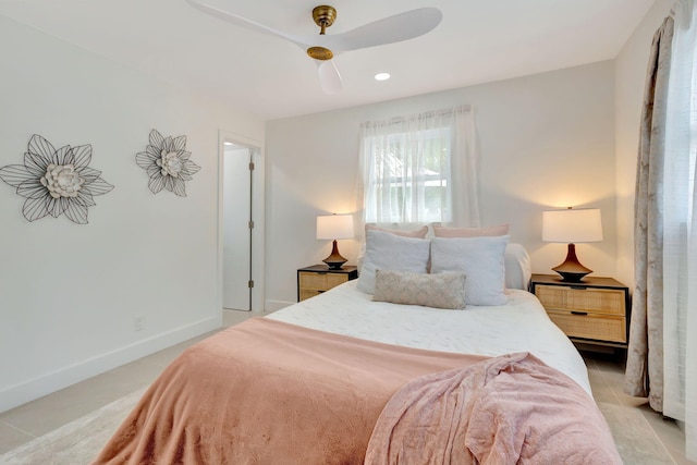 tiled bedroom featuring ceiling fan