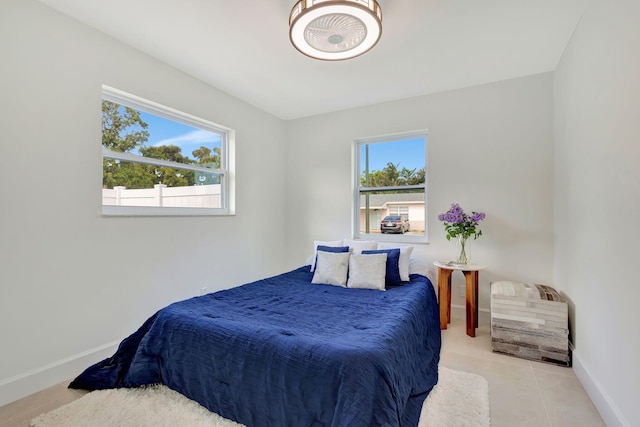 tiled bedroom featuring multiple windows