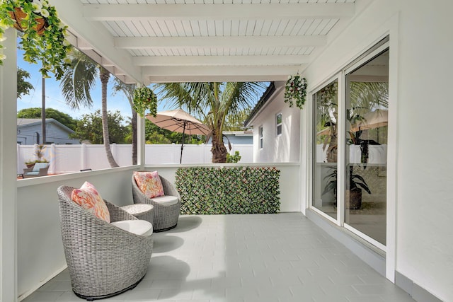 sunroom with beamed ceiling