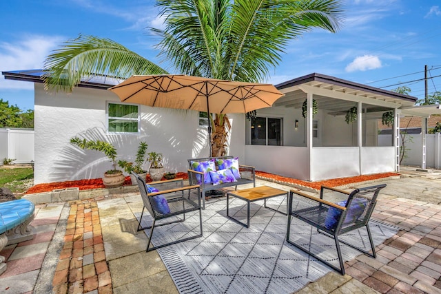 view of patio / terrace featuring outdoor lounge area and a sunroom