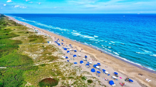 bird's eye view featuring a view of the beach and a water view