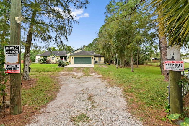 ranch-style home featuring a front yard and a garage