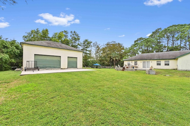 view of yard featuring a patio area and a garage