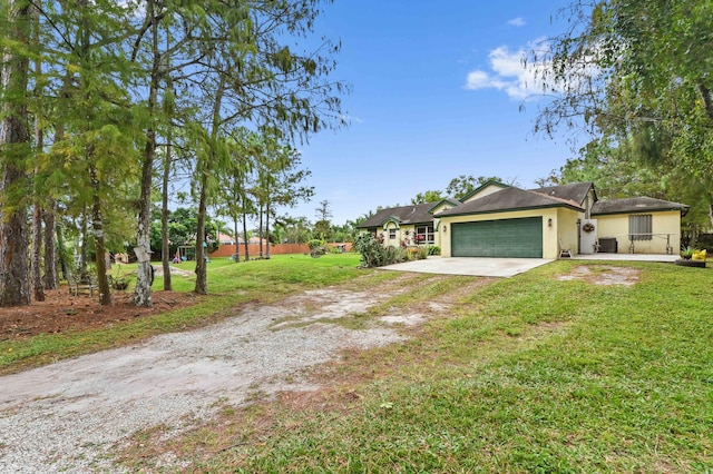 single story home featuring a front yard and a garage