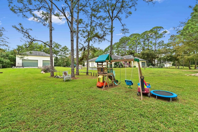 view of playground with a lawn, a trampoline, and an outdoor structure