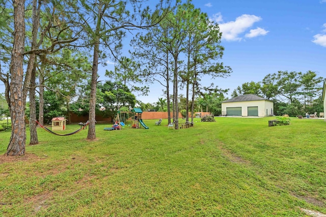 view of yard with a playground and a garage