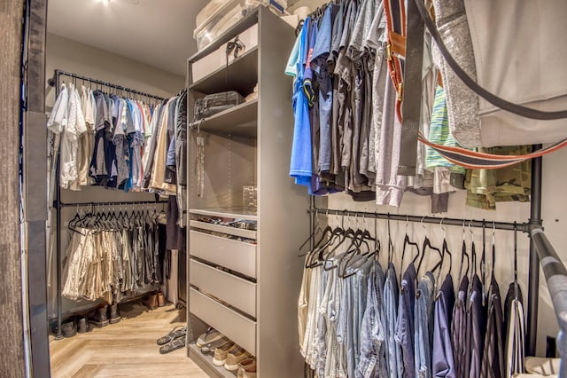 walk in closet featuring parquet flooring