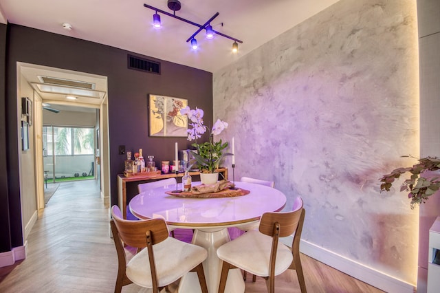 dining space with light parquet flooring