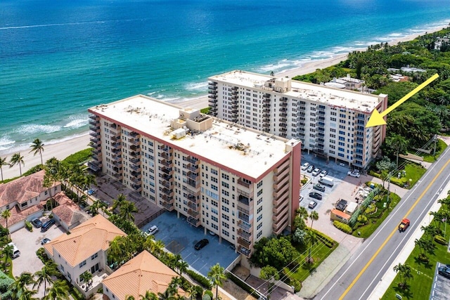 drone / aerial view featuring a water view and a beach view