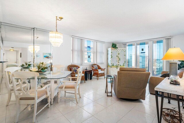 1147 Hillsboro Mile Unit 701, Hillsboro Beach, FL 33062 - dining space featuring an inviting chandelier, light tile patterned floors, and expansive windows