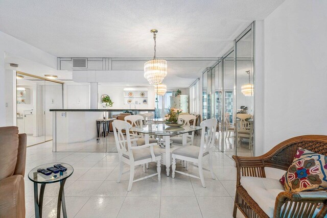 1147 Hillsboro Mile Unit 701, Hillsboro Beach, FL 33062 - dining space with visible vents, light tile patterned flooring, and a notable chandelier