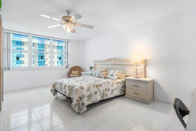 1147 Hillsboro Mile Unit 701, Hillsboro Beach, FL 33062 - bedroom featuring a textured ceiling, ceiling fan, and light tile patterned floors