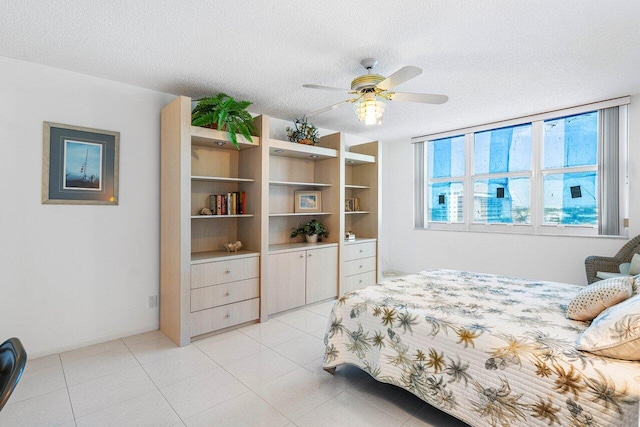 1147 Hillsboro Mile Unit 701, Hillsboro Beach, FL 33062 - bedroom featuring a ceiling fan, a textured ceiling, and light tile patterned floors