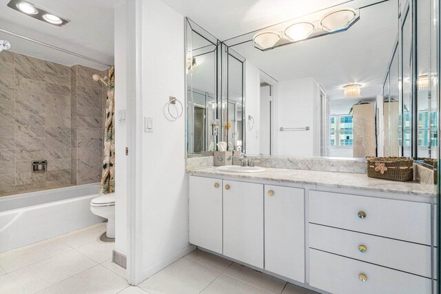 1147 Hillsboro Mile Unit 701, Hillsboro Beach, FL 33062 - bathroom featuring tile patterned flooring, vanity, toilet, shower / bathtub combination with curtain, and baseboards