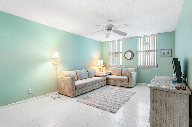 1147 Hillsboro Mile Unit 701, Hillsboro Beach, FL 33062 - living area featuring baseboards, ceiling fan, light tile patterned flooring, and a textured ceiling