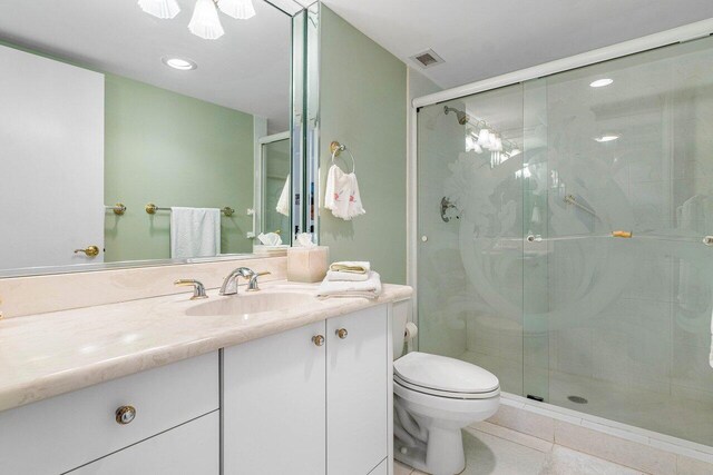 1147 Hillsboro Mile Unit 701, Hillsboro Beach, FL 33062 - bathroom with vanity, toilet, tile patterned floors, visible vents, and a stall shower