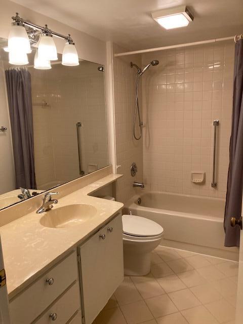 full bathroom featuring tile patterned flooring, shower / tub combo, vanity, and toilet