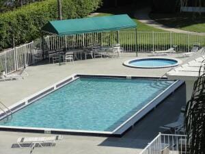 2811 Village Blvd Unit 106, West Palm Beach, FL 33409 - community pool featuring a hot tub, fence, and a patio area