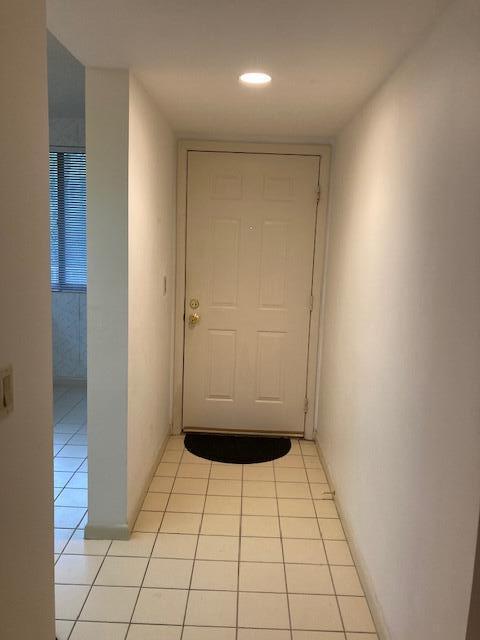 hall with light tile patterned floors