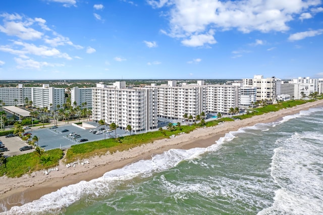 drone / aerial view featuring a water view and a beach view