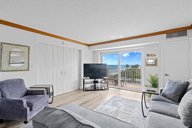 3301 S Ocean Blvd Unit 405, Highland Beach, FL 33487 - living room with crown molding, wood finished floors, and a textured ceiling