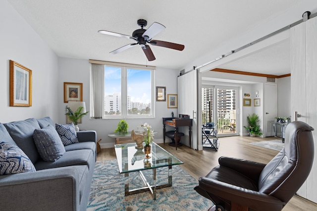 3301 S Ocean Blvd Unit 405, Highland Beach, FL 33487 - living room featuring ceiling fan, wood finished floors, and a barn door