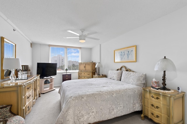 carpeted bedroom with a textured ceiling and ceiling fan