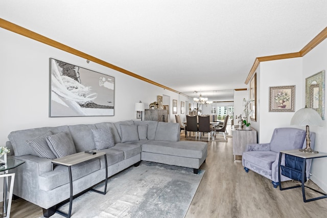 living room with an inviting chandelier, crown molding, and wood-type flooring