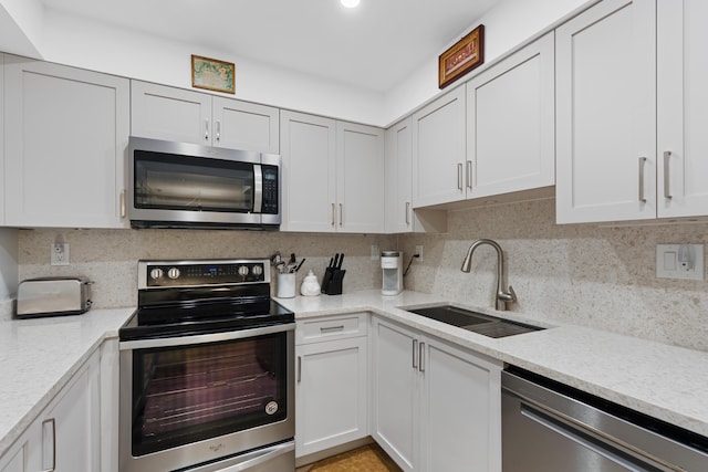 3301 S Ocean Blvd Unit 405, Highland Beach, FL 33487 - kitchen featuring appliances with stainless steel finishes, a sink, light countertops, and decorative backsplash