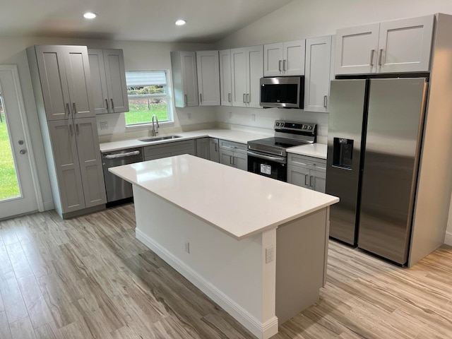 kitchen with light hardwood / wood-style floors, sink, and appliances with stainless steel finishes