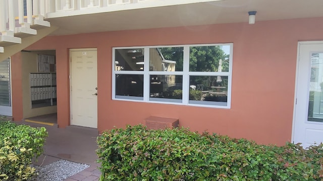 view of exterior entry with a balcony